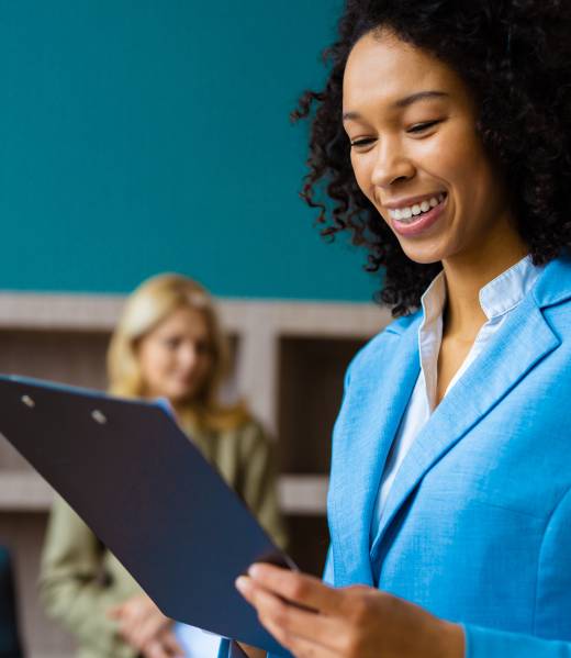 Beautiful adult businesswoman with elegant dress standing in a conference room - African american woman portrait in a business meeting, concepts about business and people